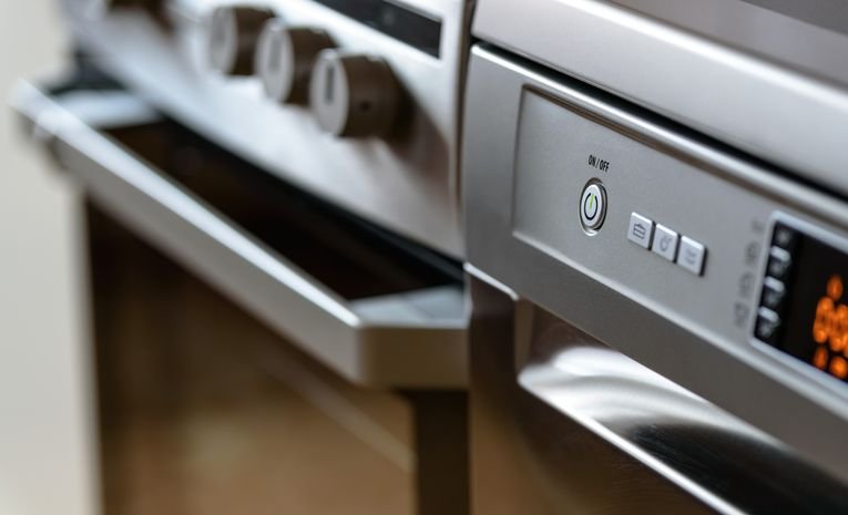 Stainless steel dishwasher and oven in a modern kitchen