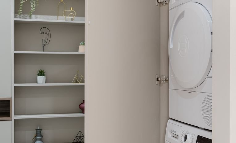 Washing machine and dryer in a home laundry cabinet