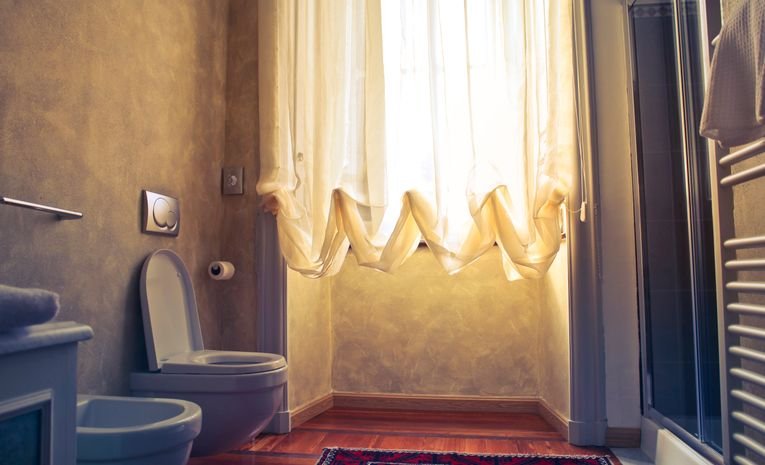 White ceramic toilet bowl in a bathroom