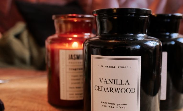 Lit candle on a wooden table in a cozy home